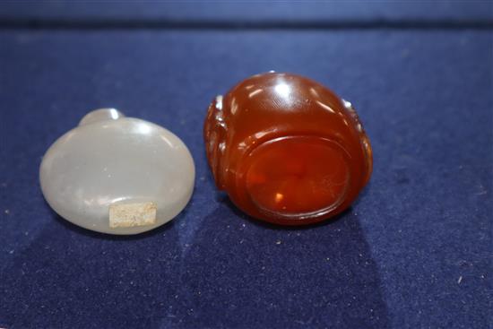 A Chinese agate snuff bottle and an amber glass snuff bottle